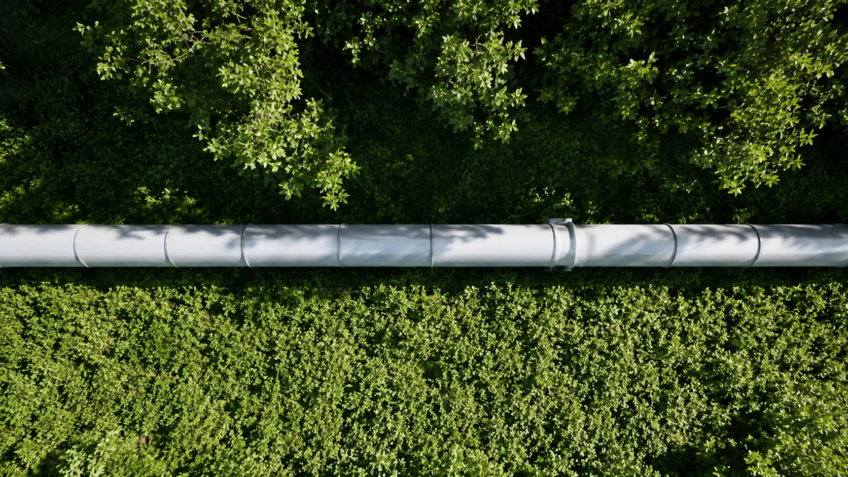 Aerial view of a pipeline corridor running through forest