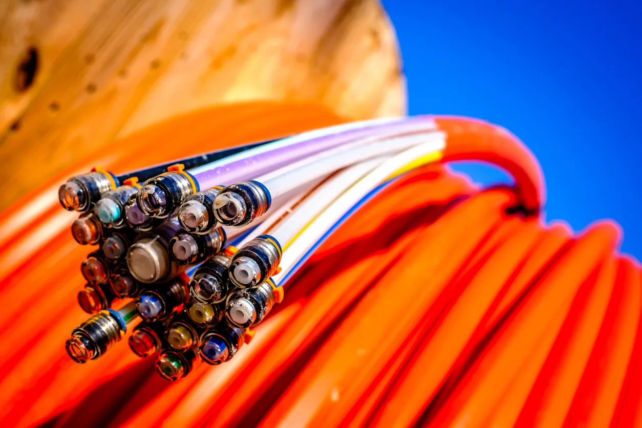 Fiber-optic cables on an orange reel